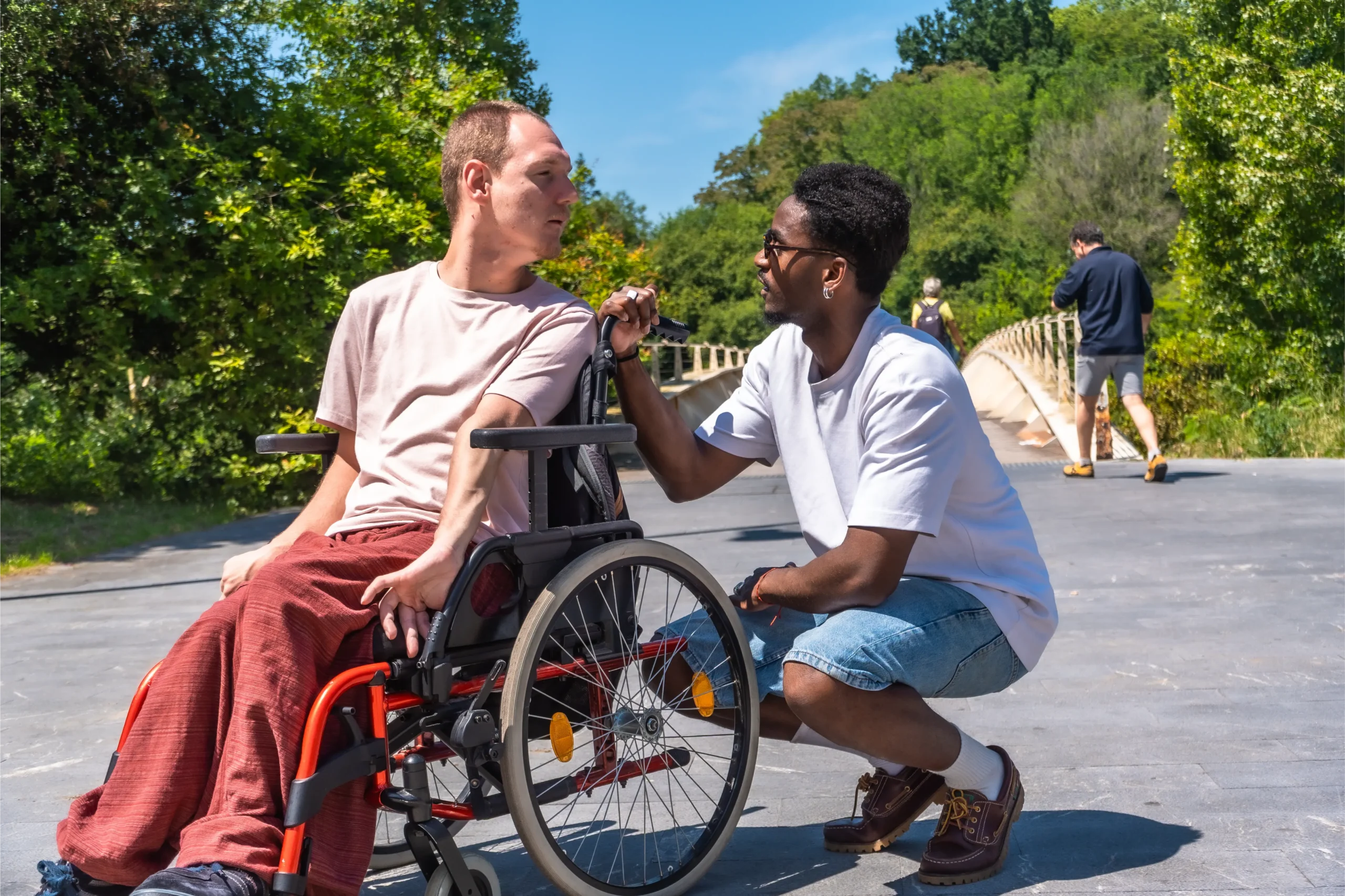 Two young men having a close conversation in the sun